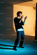 Young man expressing emotions in dramatic studio lighting