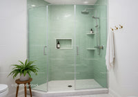 Modern glass shower with green tiles and fresh decor