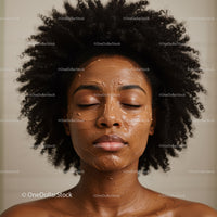 Young African American Woman with Curly Hair Enjoying Facial Skincare