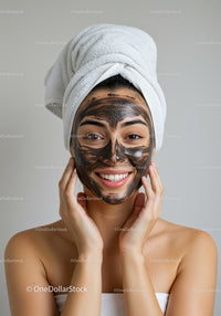 Young Woman with Facial Mask and Towel Wrap in Spa Setting