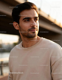 Thoughtful young man looking away with soft sunlight