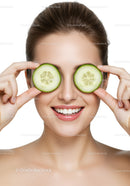 Smiling Woman Holding Fresh Cucumber Slices for Skincare and Wellness