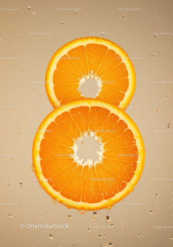 Fresh Orange Slices with Water Droplets on Beige Background
