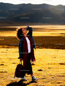 Woman enjoying sunlight in open mountain meadow