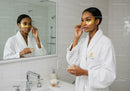Black Woman Applying Eye Patches for Skincare Routine in Bathroom