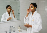 Black Woman Applying Eye Patches for Skincare Routine in Bathroom