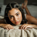 Young Woman Relaxing on Cozy Blanket with Captivating Gaze