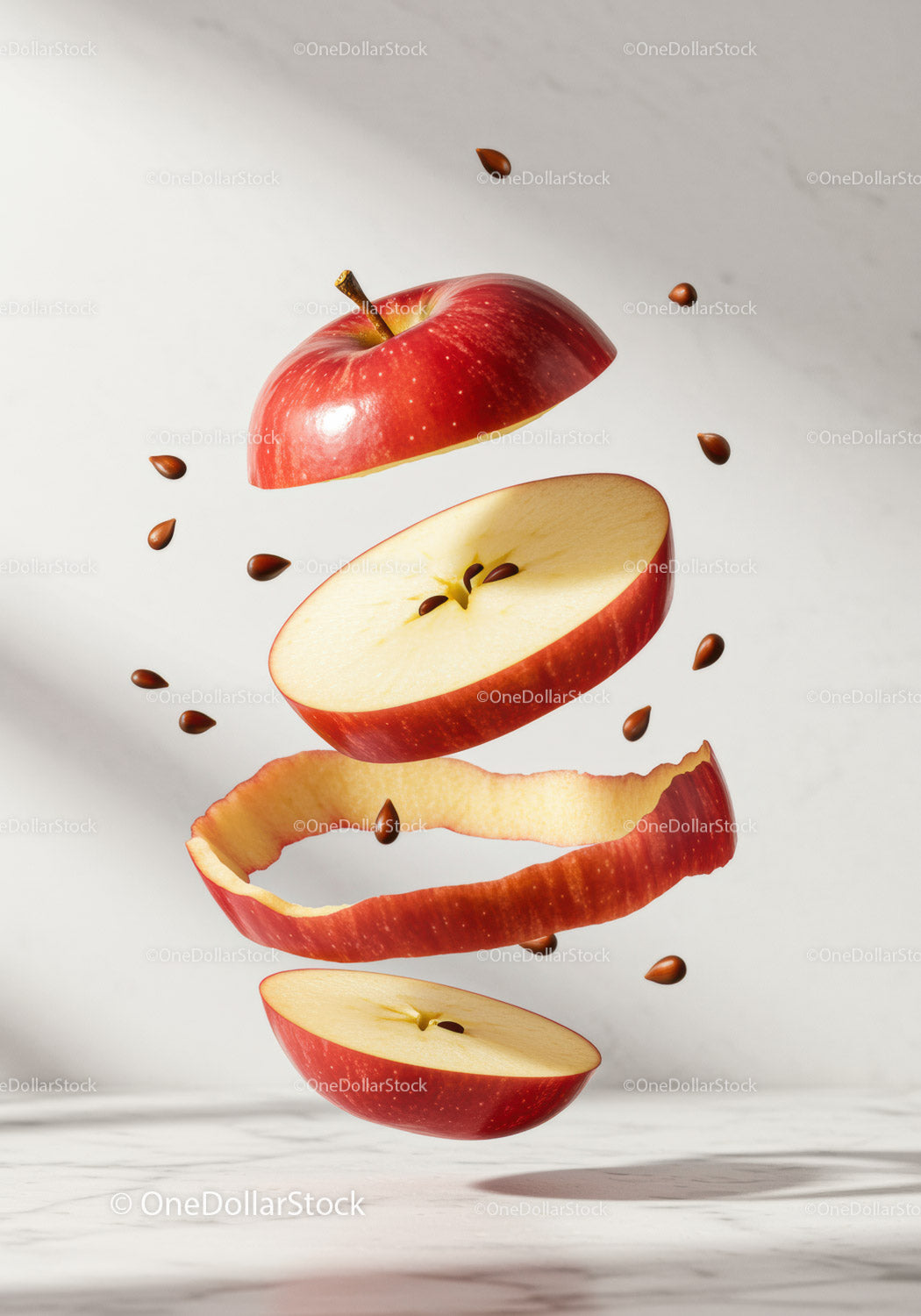 Floating Red Apple Slices with Seeds and Peel Spiral