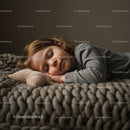 Peaceful toddler sleeping on soft knitted blanket
