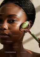 African Woman Using Jade Roller for Natural Skin Rejuvenation