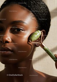African Woman Using Jade Roller for Natural Skin Rejuvenation