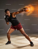 Determined female boxer throwing powerful punch