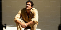 Thoughtful man sitting in soft sunlight outdoors
