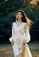 Elegant woman in flowing satin dress walking outdoors