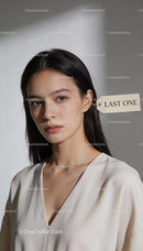 Pensive woman with last one tag on ear