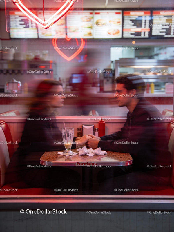 Couple Sharing Intimate Moment in Retro Diner Booth
