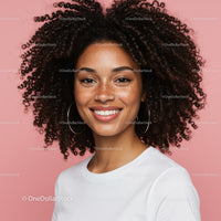 Elegant Portrait of a Woman with Curly Hair and Freckles on Pink Background