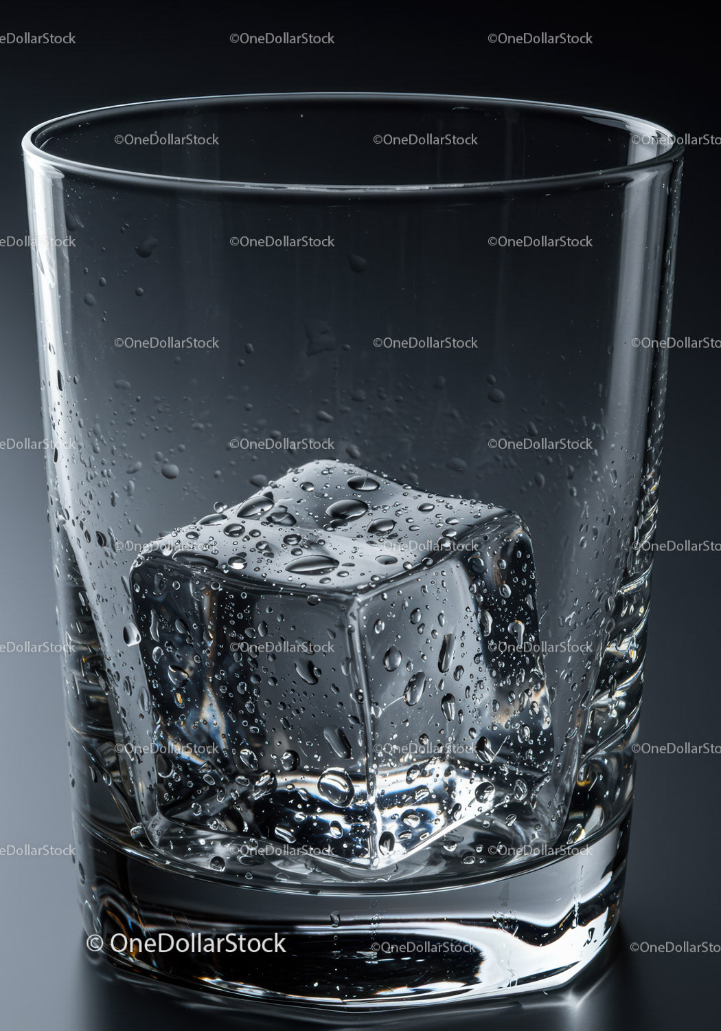 Close up of melting ice cube in clear glass