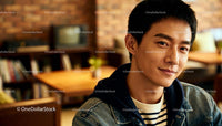 Smiling Young Man Relaxing in Cozy Cafe Interior
