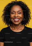 Elegant Smiling African American Woman with Curly Hair on Bright Yellow Background