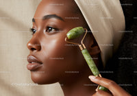 Elegant African American Woman Using Jade Roller for Facial Massage