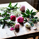 Fresh mixed flowers laying on rustic wooden table