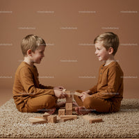 Two young boys playing with wooden blocks indoors