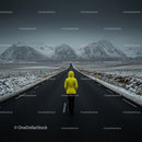 Lonely Traveler in Yellow Jacket on Snow-Covered Road