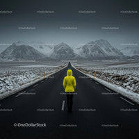 Lonely Traveler in Yellow Jacket on Snow-Covered Road