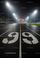 Nighttime running track with illuminated stadium scoreboard