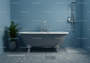 Classic freestanding bathtub in serene blue bathroom