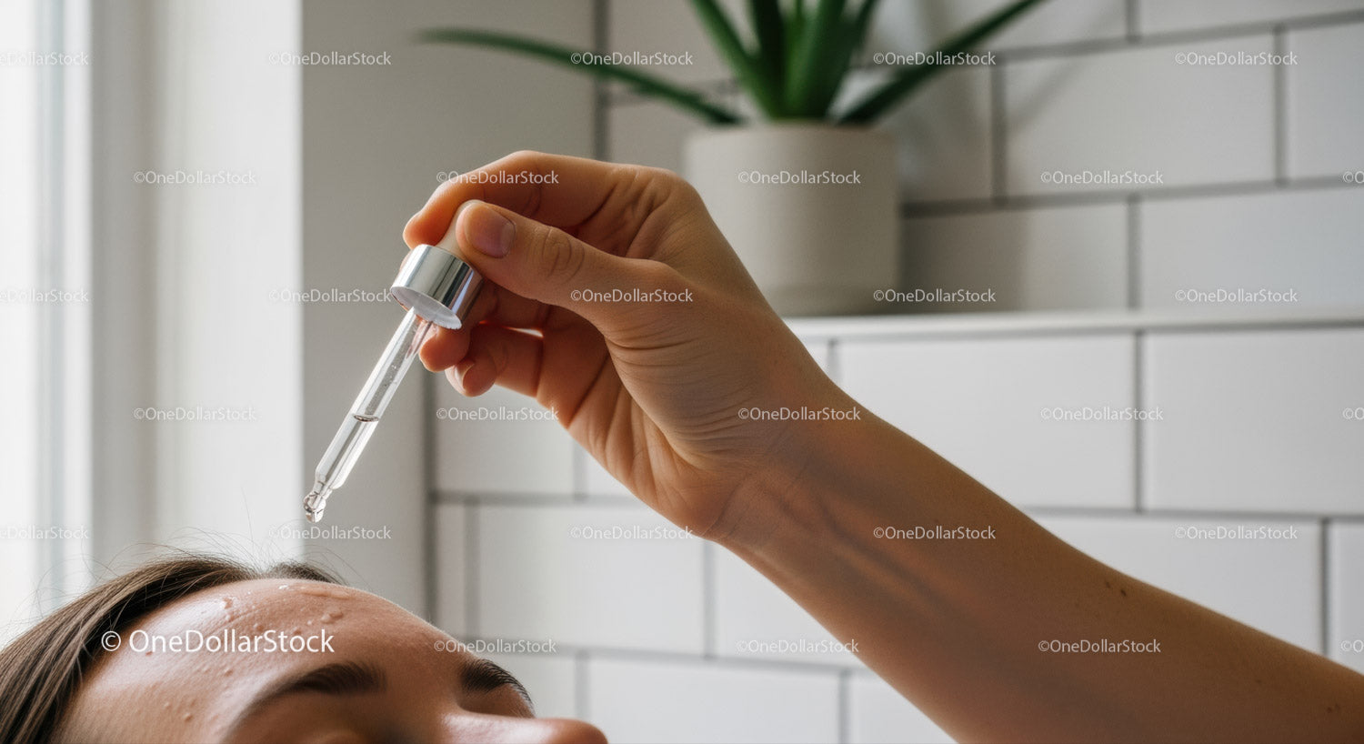 Woman Applying Skincare Serum with Dropper in Bathroom