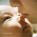 Tender moment of gentle kiss between mother and baby
