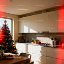 Cozy kitchen with Christmas tree and warm sunlight