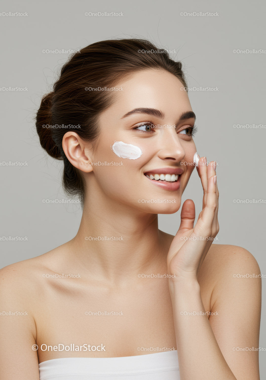 Young Woman Applying Skincare Cream with Bright Smile