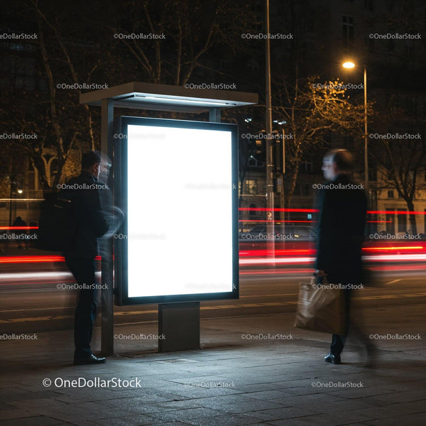 Two men passing illuminated street billboard at night JPG Mockup Image