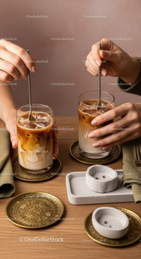 Iced Coffee with Milk and Ice in Elegant Glasses on Wooden Table