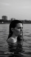 Serene Woman Portrait in Water with City Skyline in Background