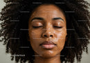 Close-up of a woman with curly hair relaxing with facial mask