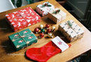 Festive Christmas gifts and ornaments on wooden table