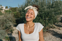 Smiling Woman Enjoying Sunny Day with Headscarf and White T-shirt