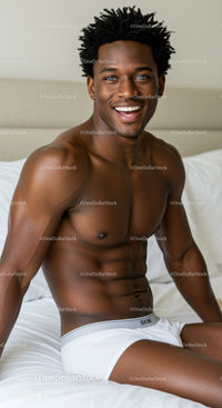 Smiling fit man relaxing on white bed at home