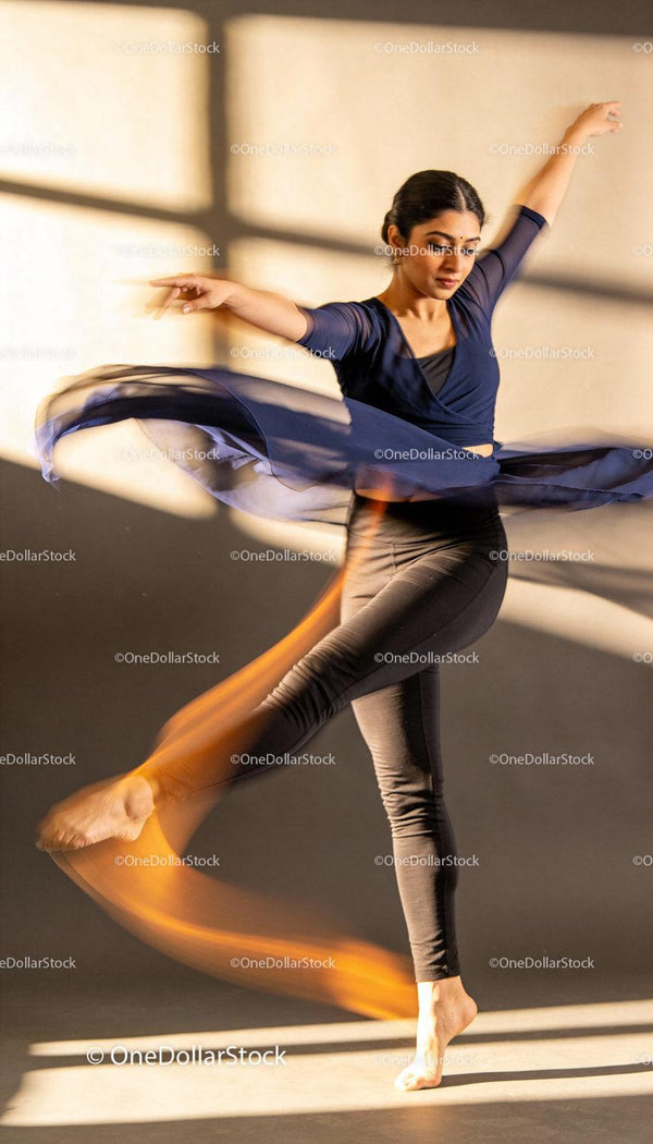 Graceful dancer spinning with flowing skirt indoors