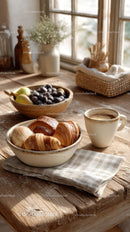 Cozy Breakfast Scene with Croissants Fruit and Coffee by Sunlit Window