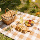 Sunny picnic setup with sandwiches and fresh fruit plate