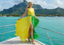 Vibrant Woman in Flowing Dress on Yacht Overlooking Tropical Mountains