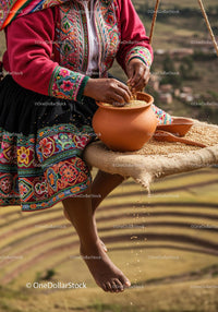 Woman in traditional Peruvian attire preparing quinoa outdoors