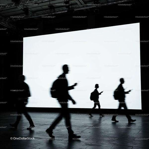 Silhouettes of people walking past bright digital screen JPG Mockup Image