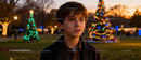 Curious boy enjoying festive Christmas lights outdoors