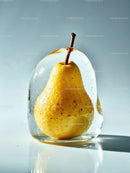 Fresh pear encased in clear ice block